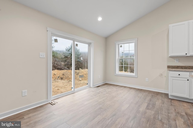 unfurnished dining area featuring vaulted ceiling, light wood finished floors, recessed lighting, and baseboards