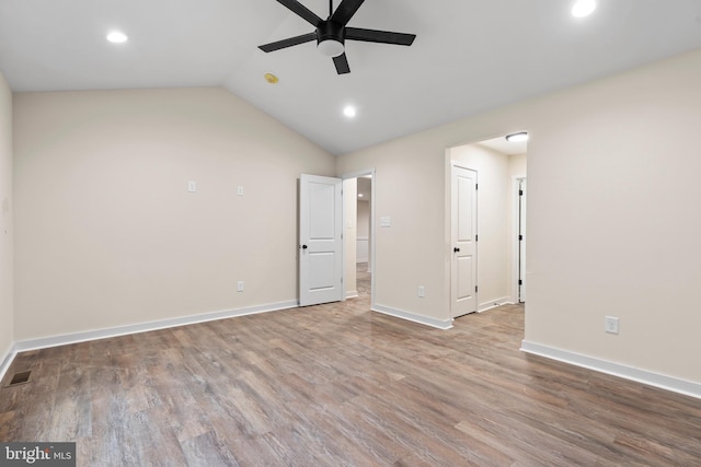 unfurnished bedroom with visible vents, baseboards, wood finished floors, vaulted ceiling, and recessed lighting