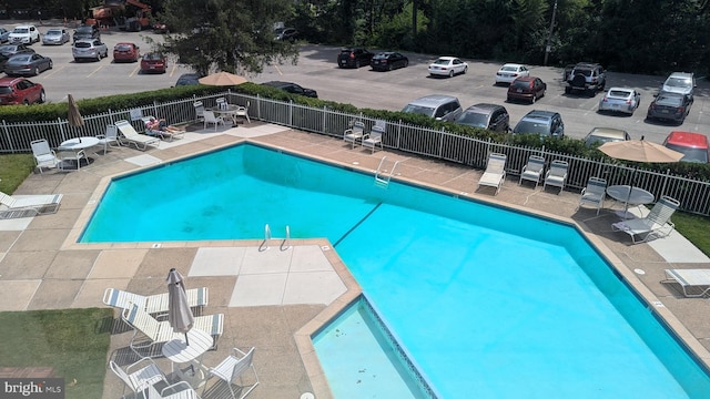 pool featuring a patio area and fence