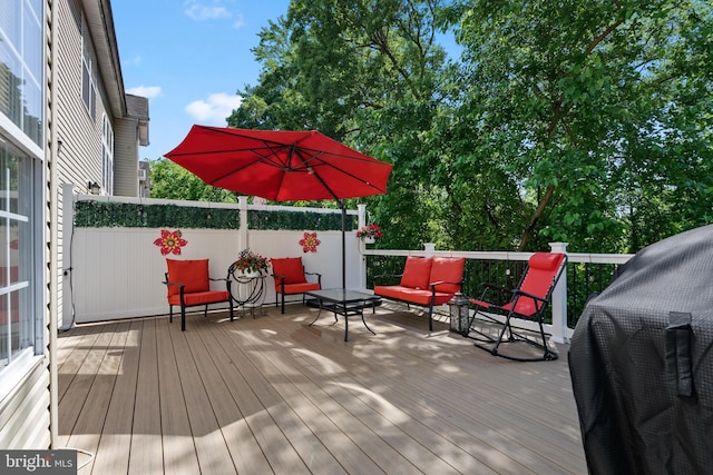 wooden deck with an outdoor living space