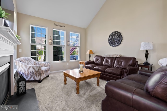 carpeted living room featuring high vaulted ceiling, a fireplace, and baseboards