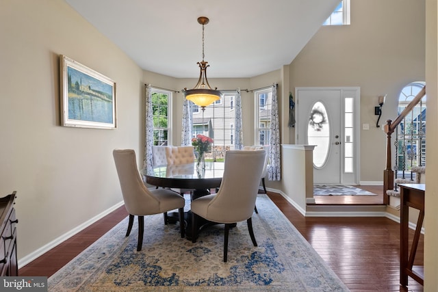 dining area featuring baseboards, stairway, and hardwood / wood-style floors