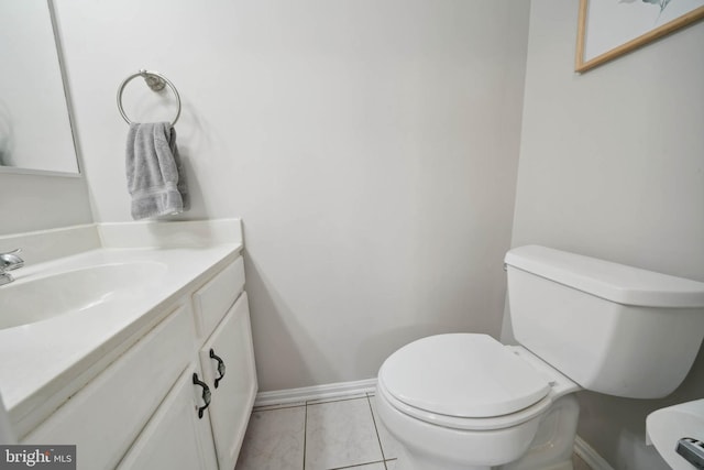 bathroom featuring vanity, toilet, and baseboards