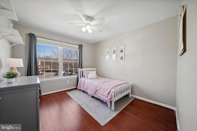 bedroom featuring a ceiling fan, baseboards, and dark wood-style flooring