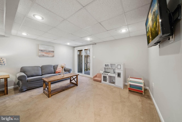 carpeted living area with recessed lighting and baseboards