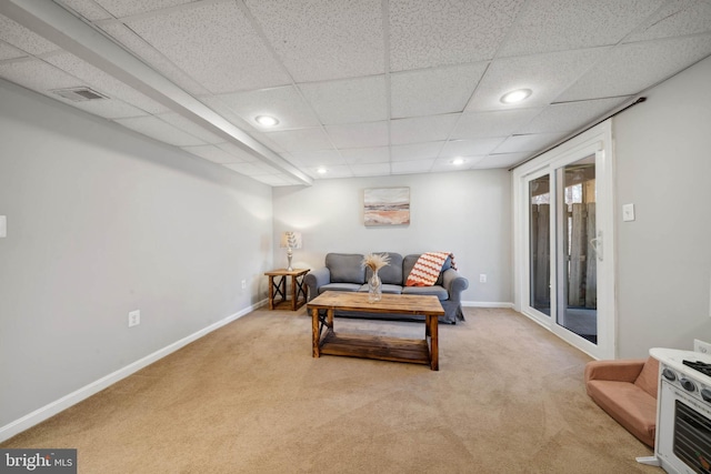 carpeted living area featuring recessed lighting, visible vents, and baseboards