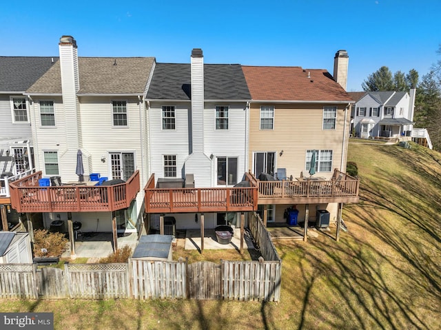 rear view of house featuring a fenced backyard, central AC unit, a deck, and a patio area