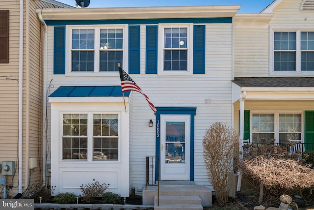 townhome / multi-family property with metal roof, a shingled roof, and a standing seam roof