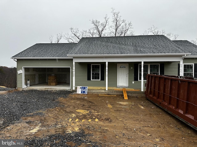 single story home with covered porch, driveway, a shingled roof, and an attached garage