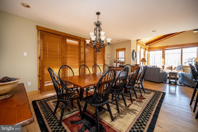 dining space with recessed lighting, a chandelier, light wood-style flooring, and vaulted ceiling