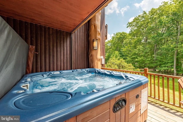 wooden deck featuring a hot tub