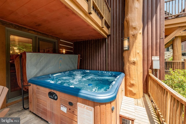 wooden terrace featuring a hot tub