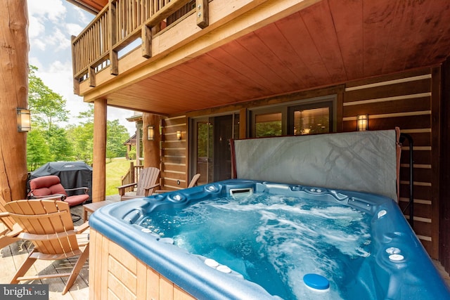 view of patio / terrace featuring grilling area and a hot tub