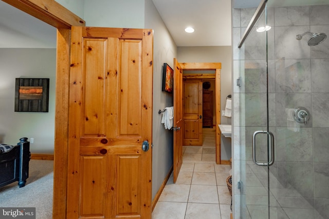 bathroom featuring tile patterned floors, baseboards, and a stall shower