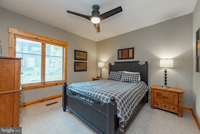 carpeted bedroom with visible vents, ceiling fan, and baseboards