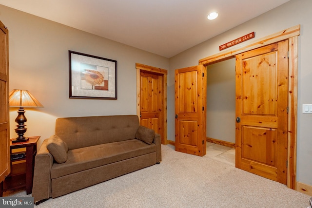 living area featuring light carpet, recessed lighting, and baseboards