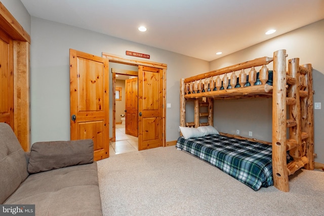 tiled bedroom featuring recessed lighting and carpet floors