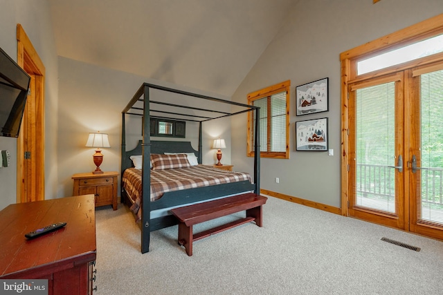 carpeted bedroom with visible vents, baseboards, and lofted ceiling