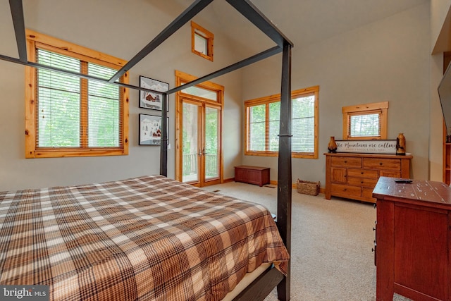 carpeted bedroom with french doors, baseboards, and access to outside