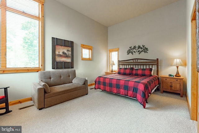 carpeted bedroom featuring visible vents and baseboards