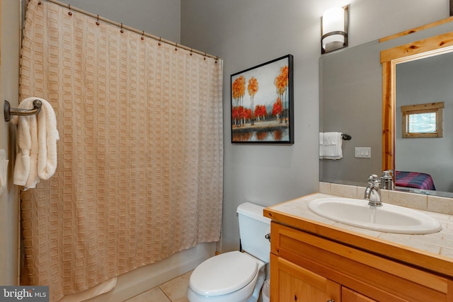 bathroom with toilet, shower / tub combo with curtain, vanity, and tile patterned flooring