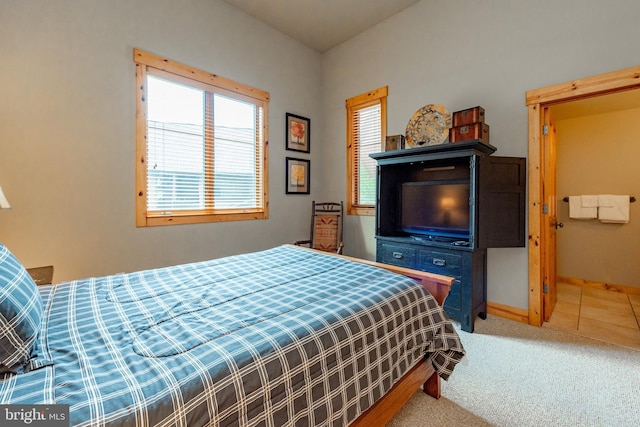 bedroom featuring tile patterned floors, carpet flooring, and baseboards