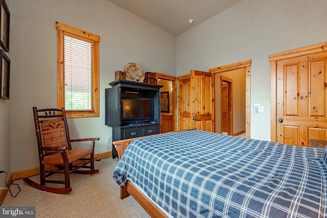 bedroom with baseboards, carpet, and vaulted ceiling