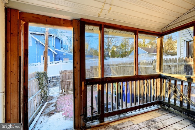 unfurnished sunroom with vaulted ceiling