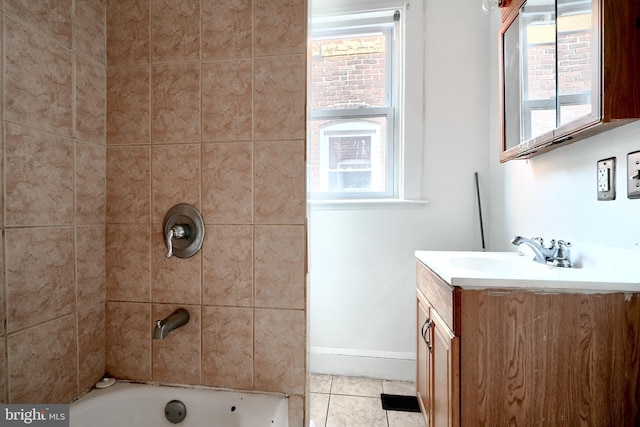 bathroom with a healthy amount of sunlight, tile patterned flooring, baseboards, and vanity