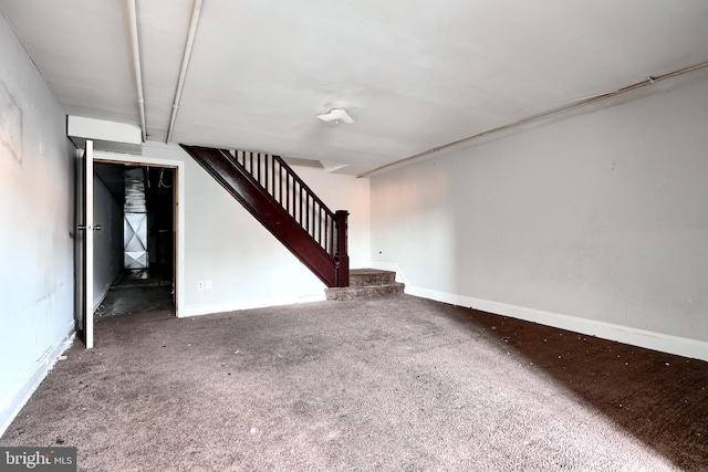 unfurnished living room with stairway, carpet flooring, and baseboards