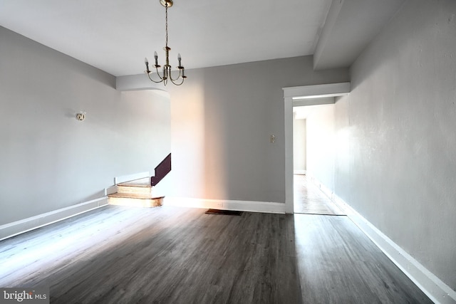 unfurnished dining area featuring stairs, wood finished floors, and baseboards