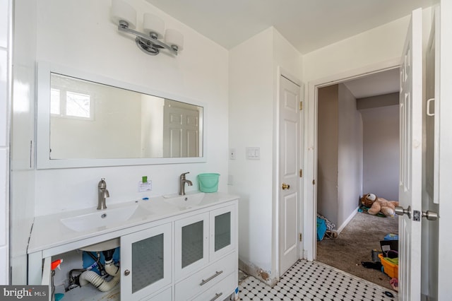 bathroom with a sink and double vanity