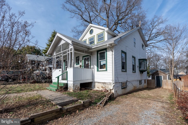 view of front of house featuring covered porch and fence