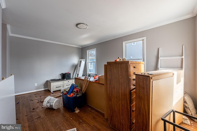 bedroom featuring baseboards, dark wood finished floors, and crown molding