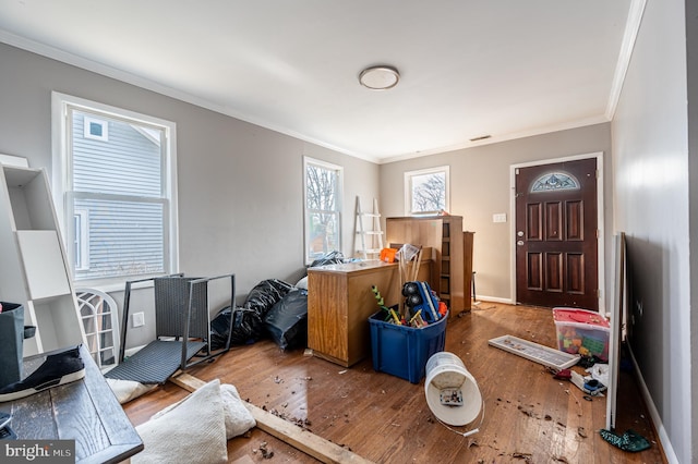 office with ornamental molding, visible vents, baseboards, and hardwood / wood-style flooring