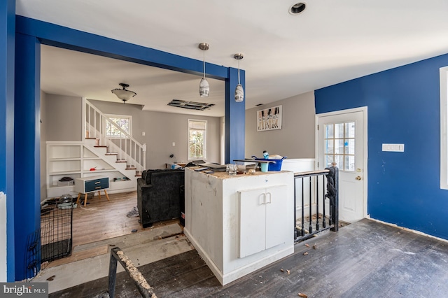 kitchen with hanging light fixtures and wood finished floors