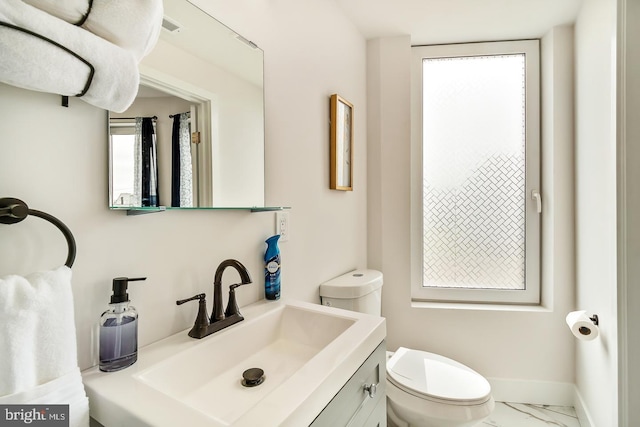 bathroom featuring visible vents, baseboards, toilet, marble finish floor, and vanity