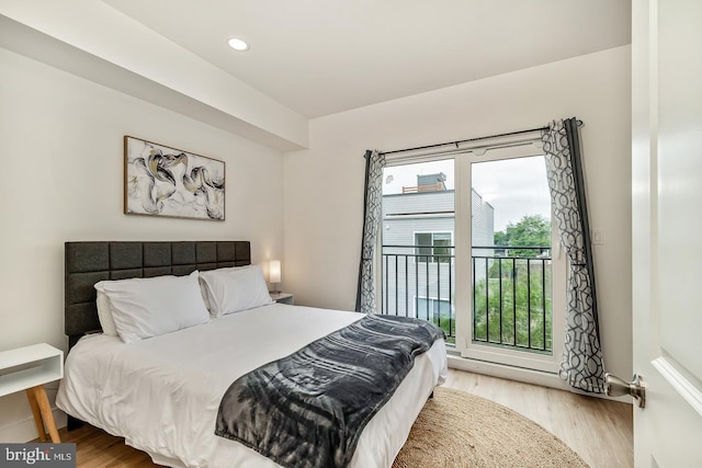 bedroom featuring access to outside, wood finished floors, and recessed lighting