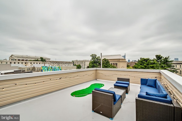 view of patio / terrace with a view of city, an outdoor hangout area, and a balcony