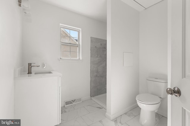 bathroom with toilet, visible vents, baseboards, marble finish floor, and a tile shower