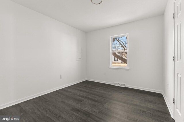 unfurnished bedroom featuring baseboards, visible vents, and dark wood-style flooring