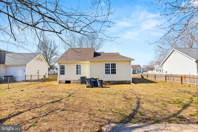 back of house with fence and a yard