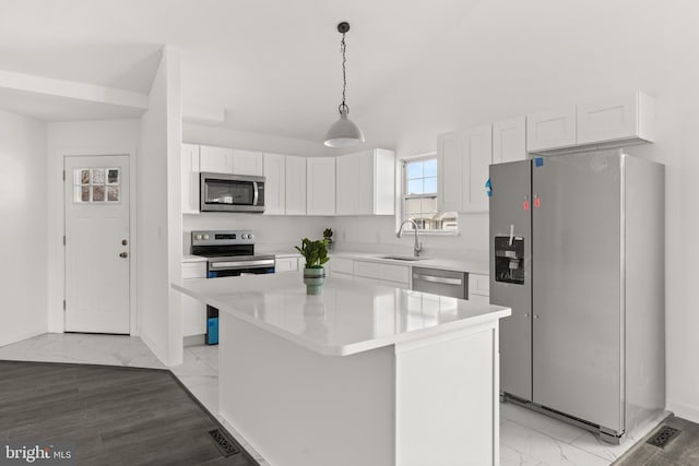 kitchen featuring stainless steel appliances, a sink, white cabinetry, marble finish floor, and light countertops