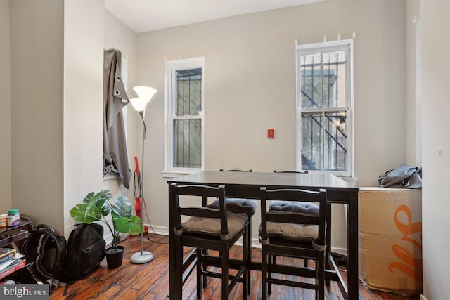 dining room with baseboards and wood finished floors