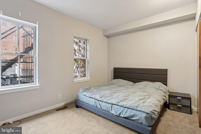 bedroom featuring carpet, visible vents, and baseboards