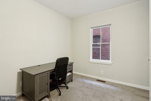 office area with light carpet, visible vents, and baseboards