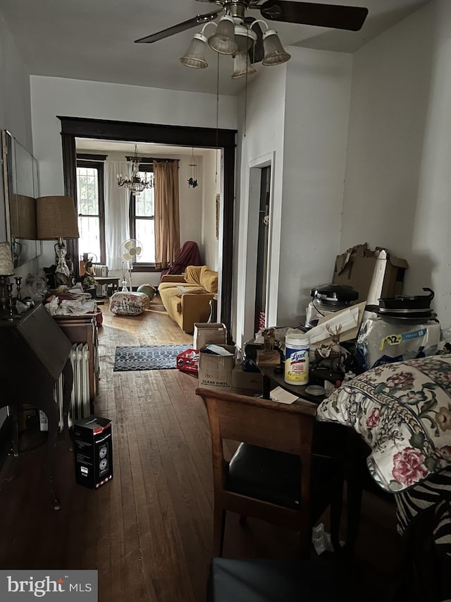 dining space with a ceiling fan and wood-type flooring