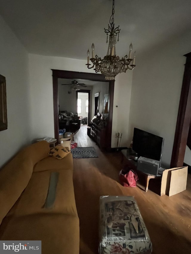 living room with a notable chandelier and wood finished floors