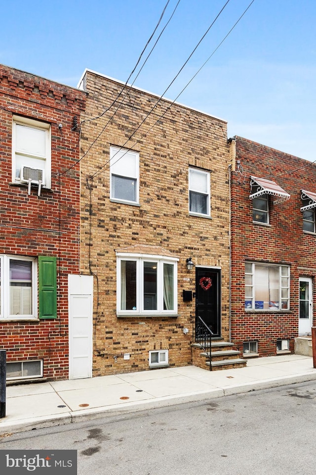 view of property featuring brick siding