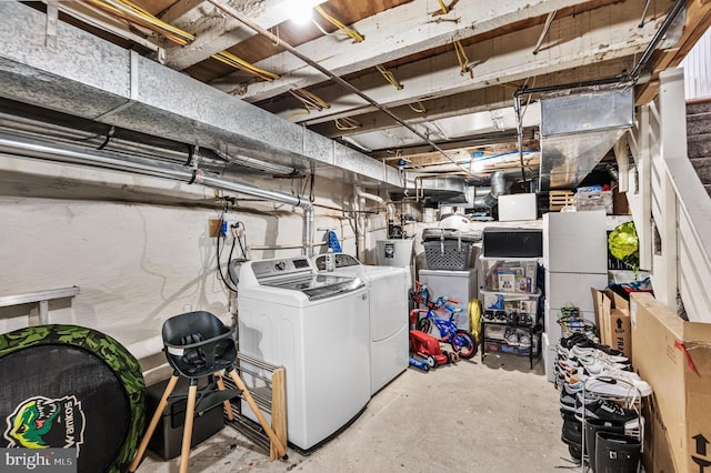 unfinished below grade area featuring washer and dryer